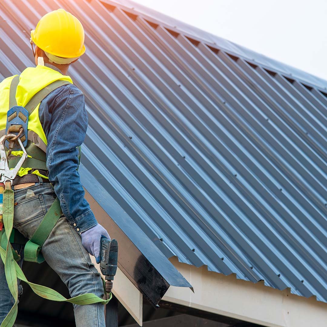 Roof worker inspecting roof