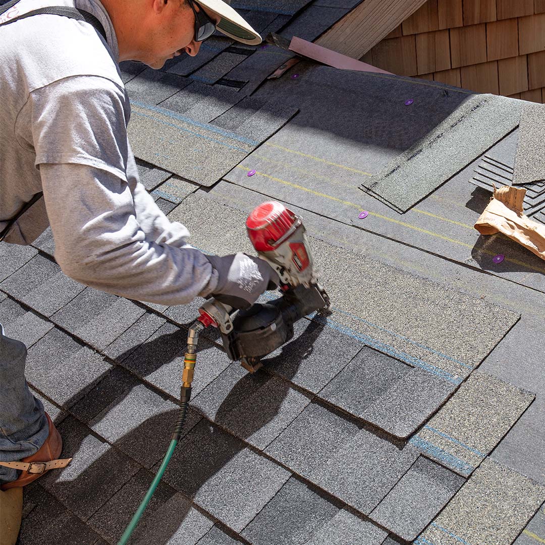 Man installing new shingles
