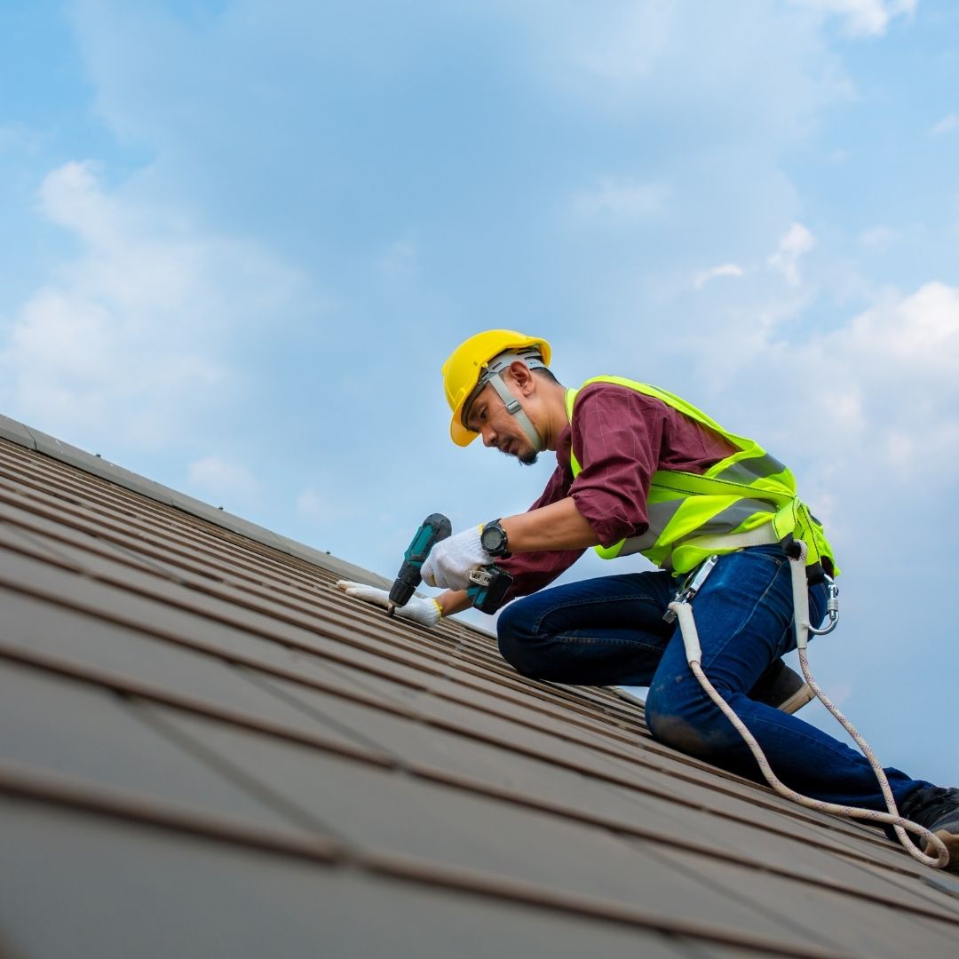 Man repairing roof shingles